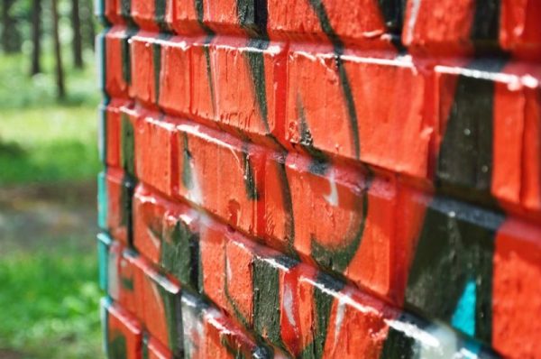 21821896 - graffiti brick wall is photographed close-up with the diminishing perspective