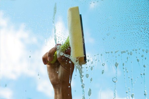 17022926 - human hand washing window in nice summer day