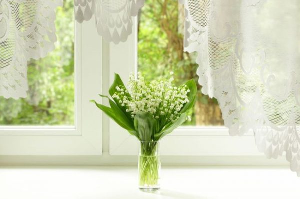 14182218 - bouquet of lily of the valley on the windowsill